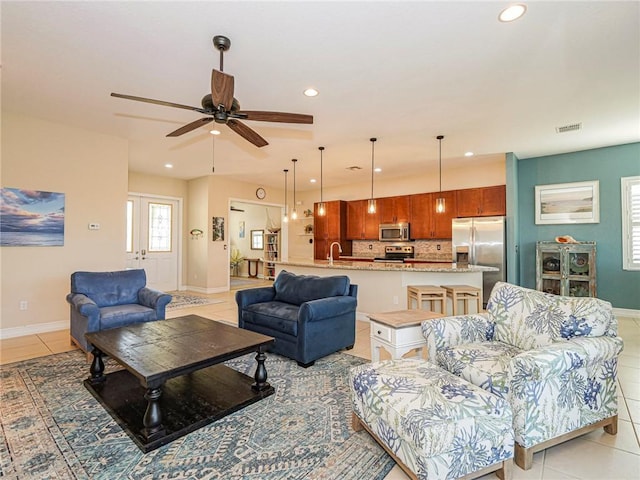 living area with baseboards, light tile patterned flooring, visible vents, and recessed lighting