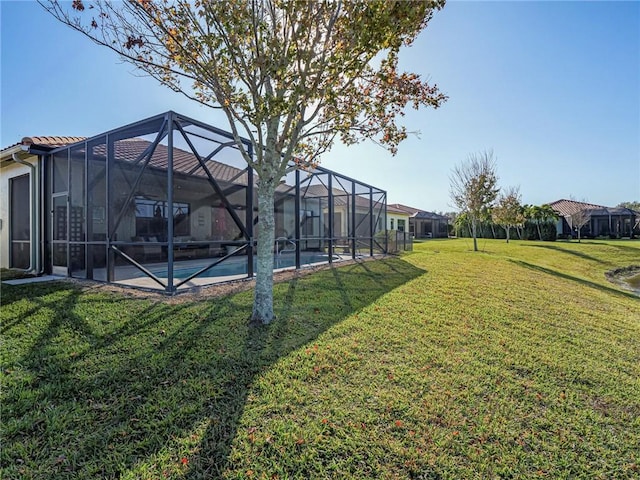 view of yard with glass enclosure and an outdoor pool