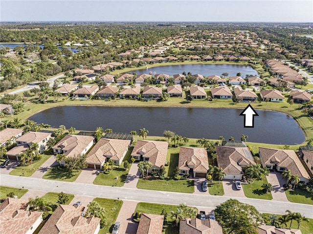 birds eye view of property featuring a residential view and a water view