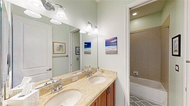 full bathroom featuring double vanity, a sink, and shower / tub combination