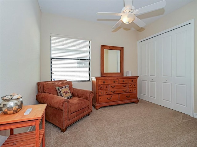 sitting room with light carpet and a ceiling fan