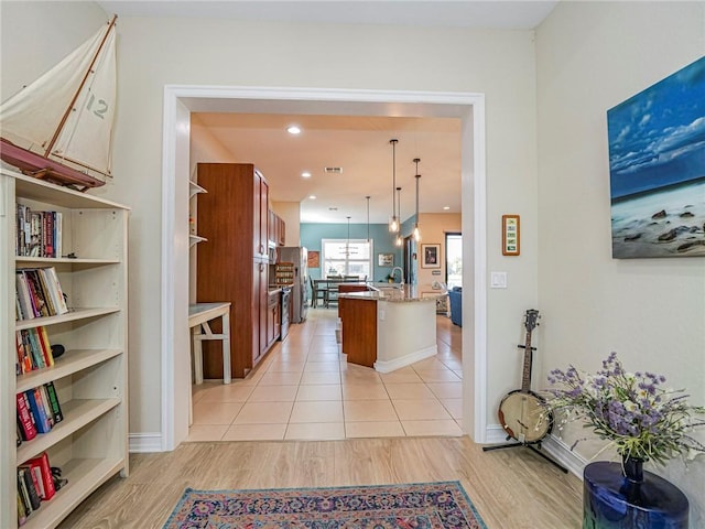 interior space featuring baseboards, light wood-style flooring, and recessed lighting