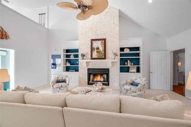 carpeted living room with high vaulted ceiling, built in features, a large fireplace, and ceiling fan