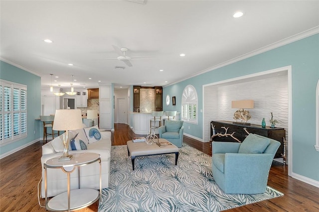 living room featuring ornamental molding, ceiling fan, and light hardwood / wood-style floors