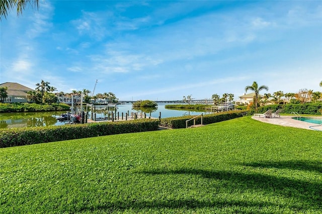 view of yard featuring a water view and a boat dock