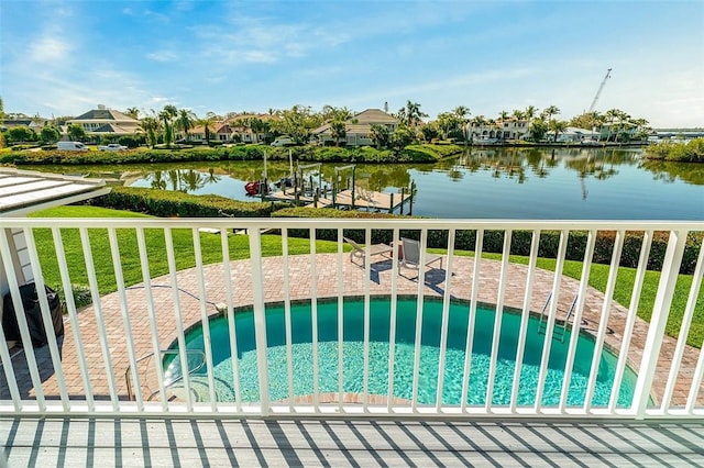 view of gate with a water view and a yard