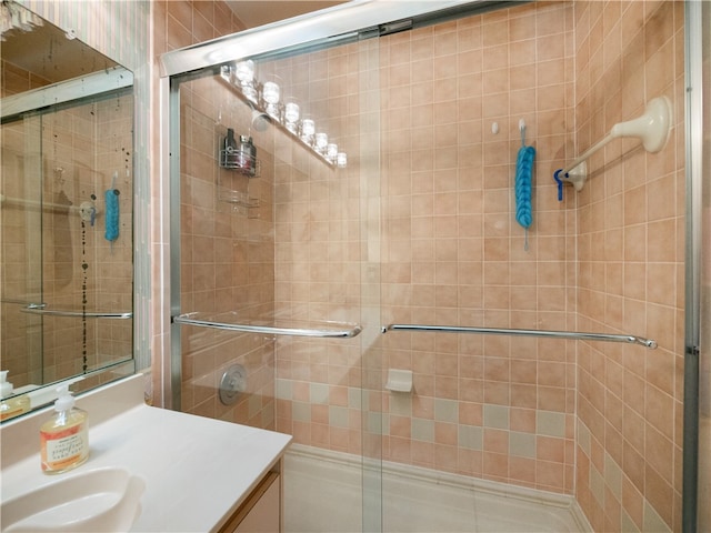 bathroom with vanity and a shower with shower door