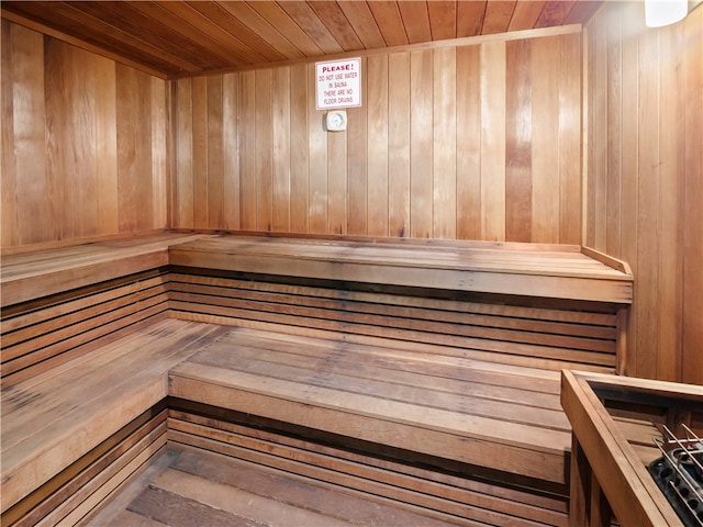 view of sauna with wood walls and wooden ceiling