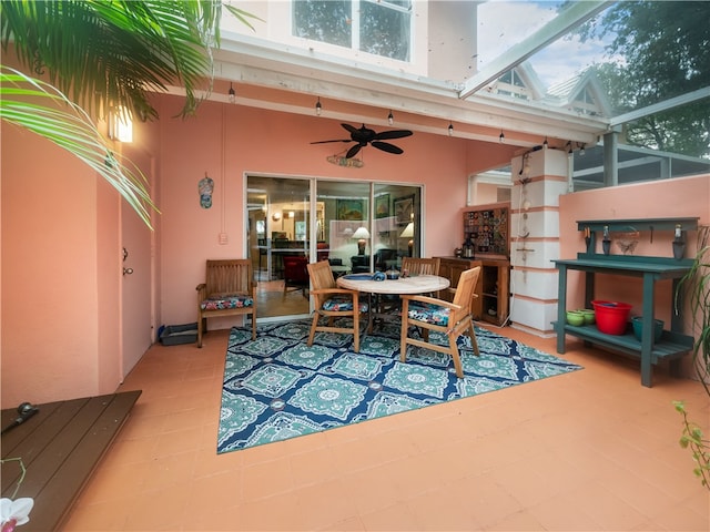 interior space featuring ceiling fan and a high ceiling