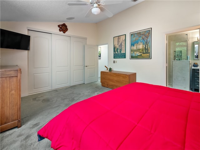 bedroom with ensuite bath, light carpet, ceiling fan, lofted ceiling, and a closet