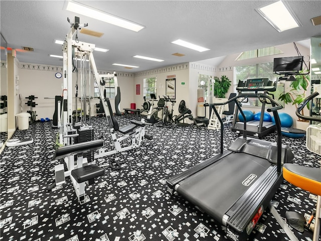 gym featuring a textured ceiling