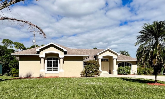 ranch-style home featuring a front yard