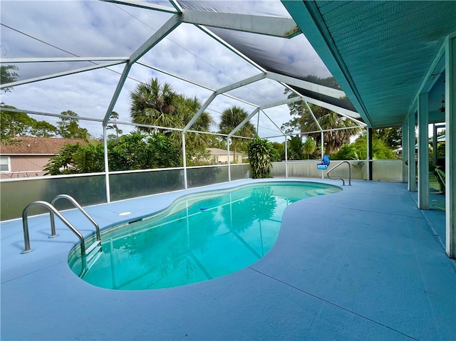 view of swimming pool featuring a lanai