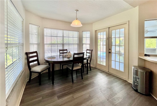 dining area featuring dark hardwood / wood-style floors, a textured ceiling, and french doors