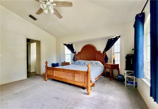 carpeted bedroom with ceiling fan and lofted ceiling