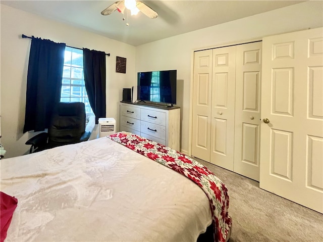 bedroom with light carpet, a closet, and ceiling fan