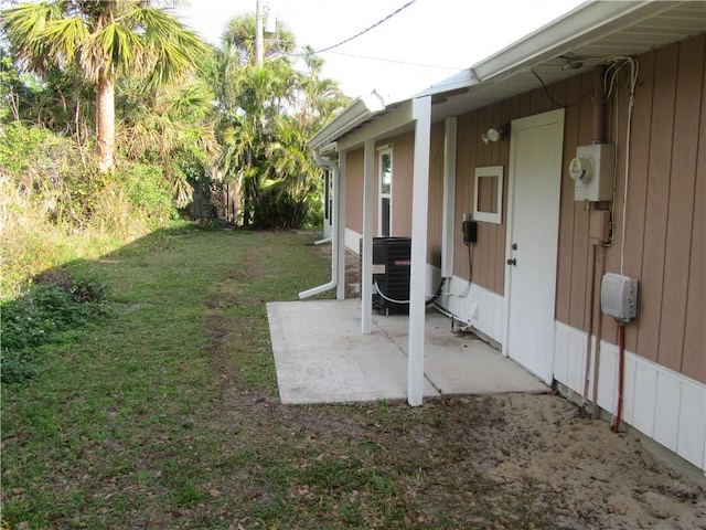 view of yard featuring central air condition unit and a patio area