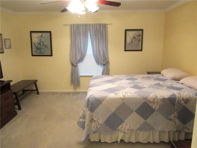 carpeted bedroom featuring crown molding, a ceiling fan, and baseboards