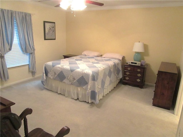 carpeted bedroom with ceiling fan, crown molding, and baseboards