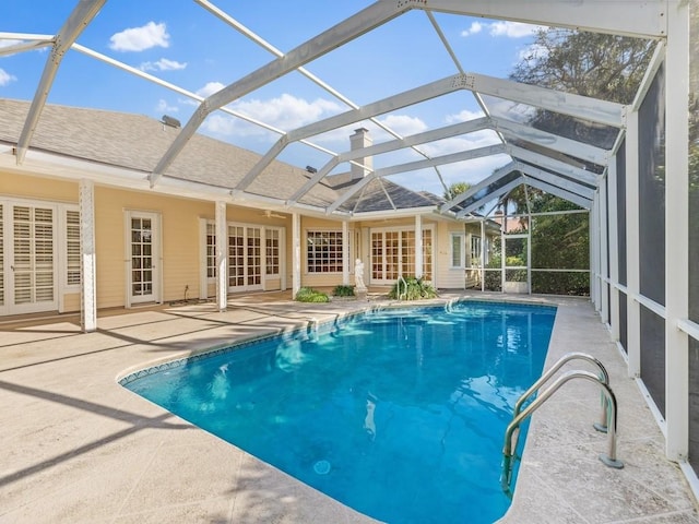 outdoor pool featuring a lanai and a patio