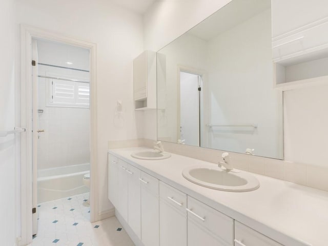 full bathroom featuring vanity, toilet, and tiled shower / bath