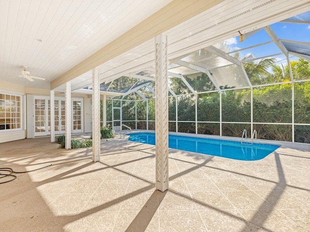 pool featuring a patio area, ceiling fan, and glass enclosure