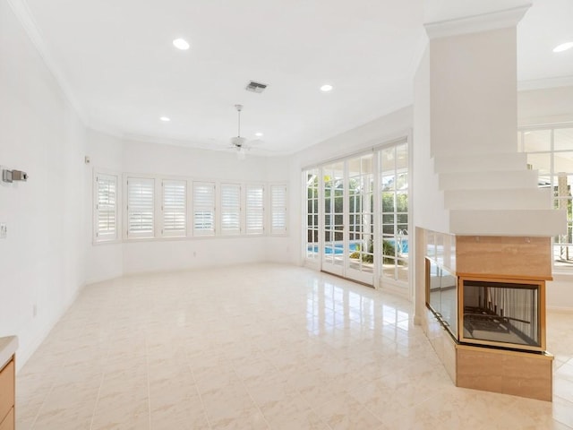 unfurnished living room featuring a multi sided fireplace, ceiling fan, and ornamental molding