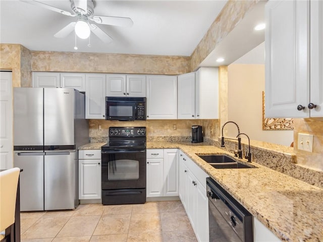 kitchen featuring sink, white cabinets, and black appliances