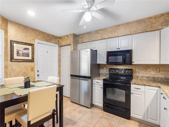 kitchen with light stone countertops, ceiling fan, black appliances, light tile patterned floors, and white cabinets