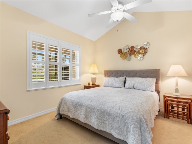 bedroom with ceiling fan, lofted ceiling, and light carpet