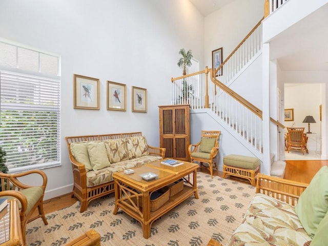 living area with a towering ceiling