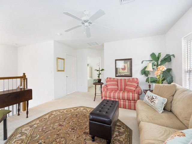 carpeted living room with ceiling fan