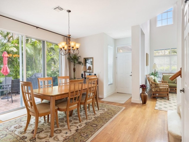 dining room featuring light hardwood / wood-style floors and an inviting chandelier