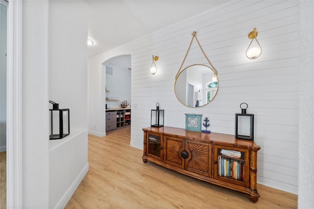 3612 2nd St SW, Vero Beach, FL 32968 - hallway featuring arched walkways, wood finished floors, and wood walls