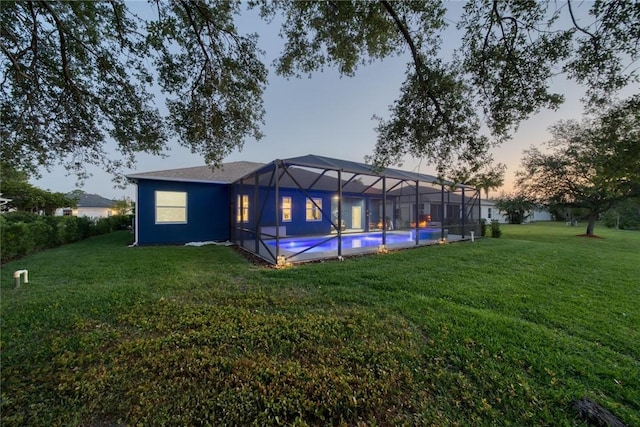 3612 2nd St SW, Vero Beach, FL 32968 - back of property at dusk featuring a yard and a lanai