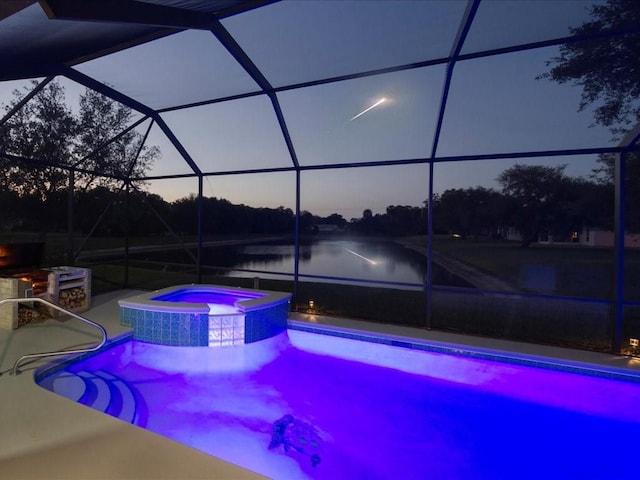 3612 2nd St SW, Vero Beach, FL 32968 - view of swimming pool featuring a lanai, a pool with connected hot tub, a patio area, and a water view