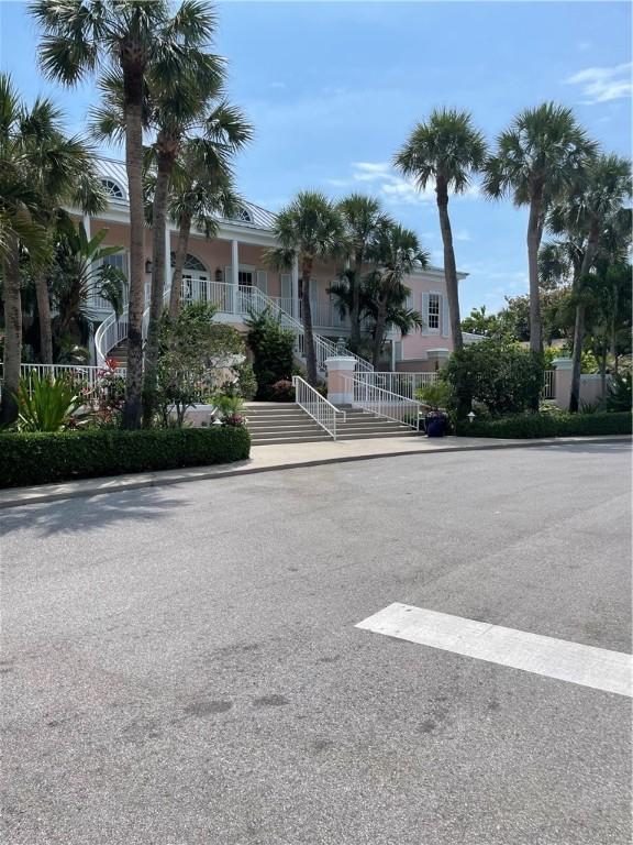 1275 Winding Oaks Cir E Unit 702, Vero Beach, FL 32963 - view of front of house with stairway and covered porch
