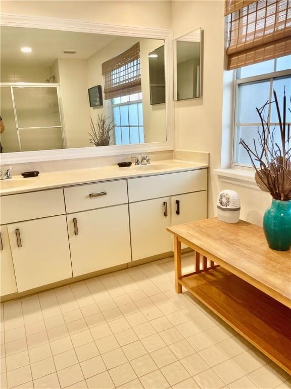1275 Winding Oaks Cir E Unit 702, Vero Beach, FL 32963 - bathroom featuring double vanity and a stall shower