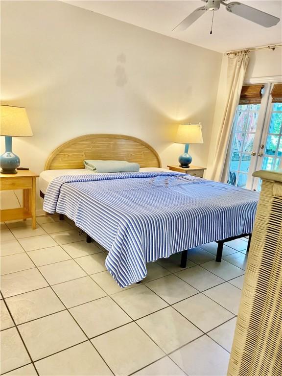 1275 Winding Oaks Cir E Unit 702, Vero Beach, FL 32963 - bedroom featuring light tile patterned flooring, access to outside, ceiling fan, and baseboards