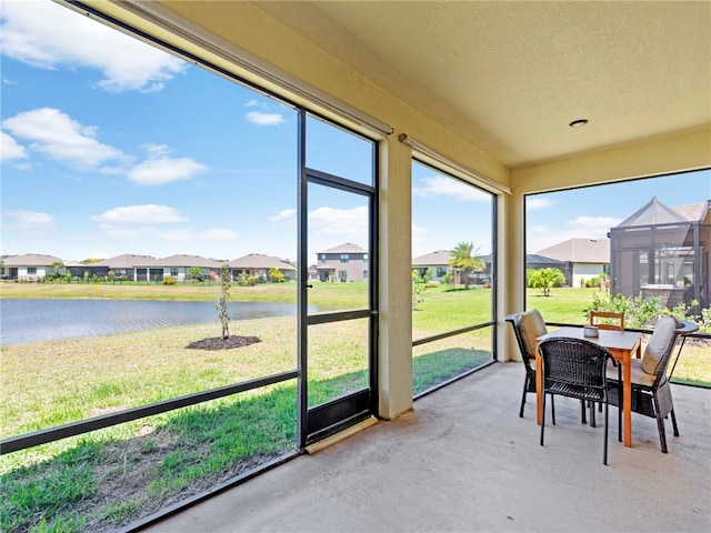 sunroom / solarium with a water view