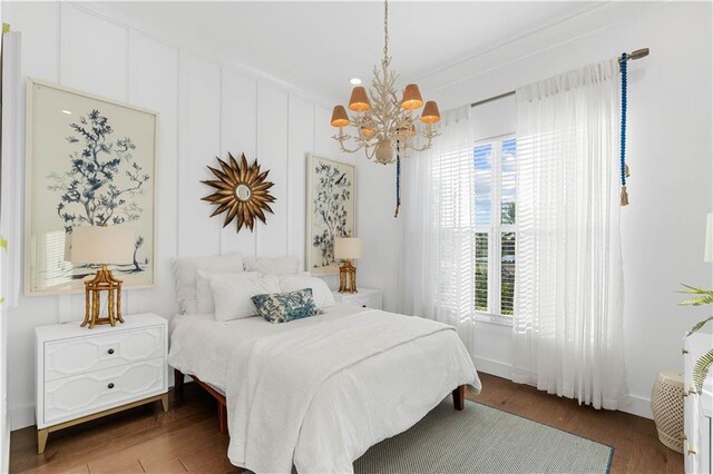 202 Strand Sq, Vero Beach, FL 32963 - bedroom featuring a chandelier, wood finished floors, and multiple windows