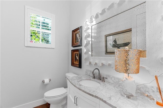 202 Strand Sq, Vero Beach, FL 32963 - bathroom with toilet, vanity, baseboards, and wood finished floors