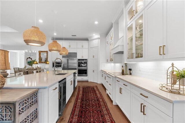 202 Strand Sq, Vero Beach, FL 32963 - kitchen featuring a sink, wine cooler, stainless steel appliances, light countertops, and recessed lighting