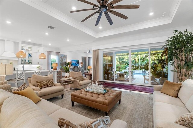 202 Strand Sq, Vero Beach, FL 32963 - living room featuring ceiling fan, crown molding, a tray ceiling, and recessed lighting
