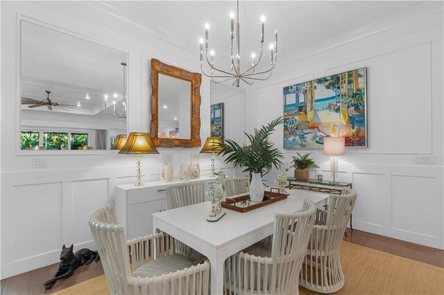 202 Strand Sq, Vero Beach, FL 32963 - dining area with a decorative wall, light wood-style floors, a chandelier, ornamental molding, and a ceiling fan