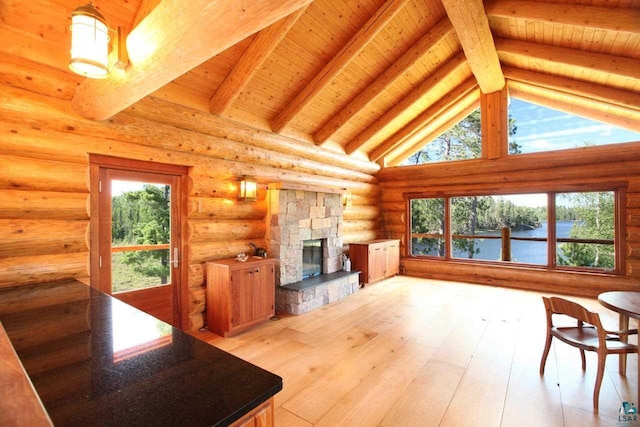 living room with log walls, wood ceiling, beamed ceiling, a stone fireplace, and light wood-type flooring