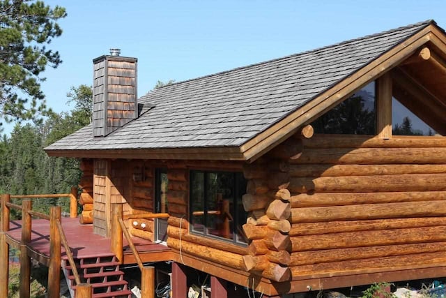 view of side of home with a wooden deck