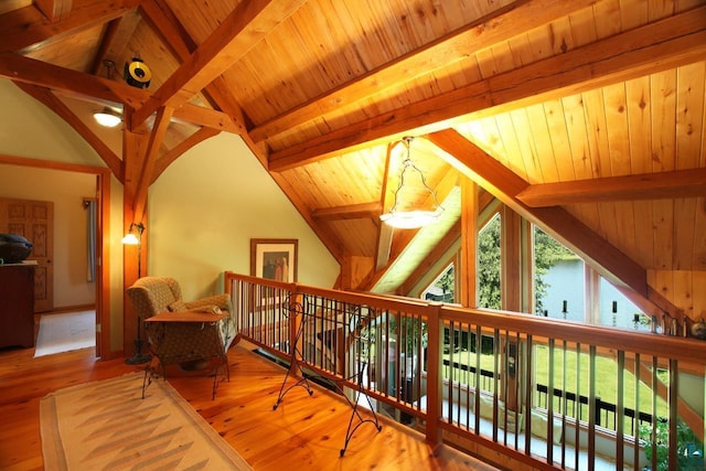 interior space featuring wooden ceiling, lofted ceiling with beams, and hardwood / wood-style flooring