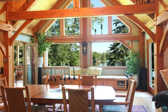 dining room with high vaulted ceiling, beam ceiling, and plenty of natural light