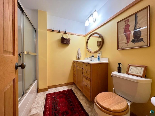 full bathroom featuring tile flooring, shower / bath combination with glass door, toilet, and vanity